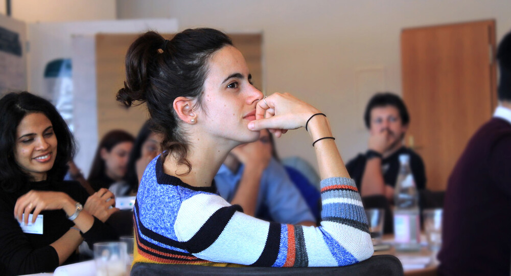 Female postdoc looks pensive, participating in training