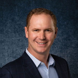 Eric Diebold's protrait photo; Eric in suit with light blue shirt within.