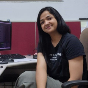 woman sitting behind desk at work smiling at the camera