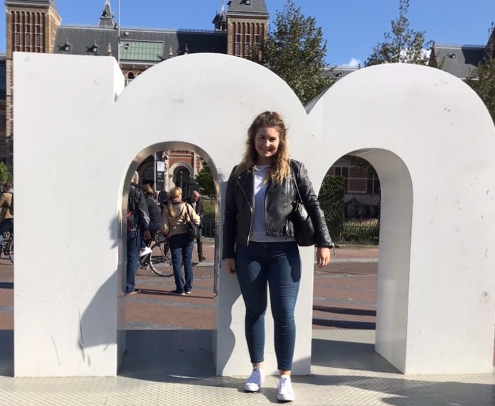 Meredith standing in front of one of the 'm' signs in Amsterdam