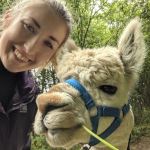 Sophie poses with an alpaca
