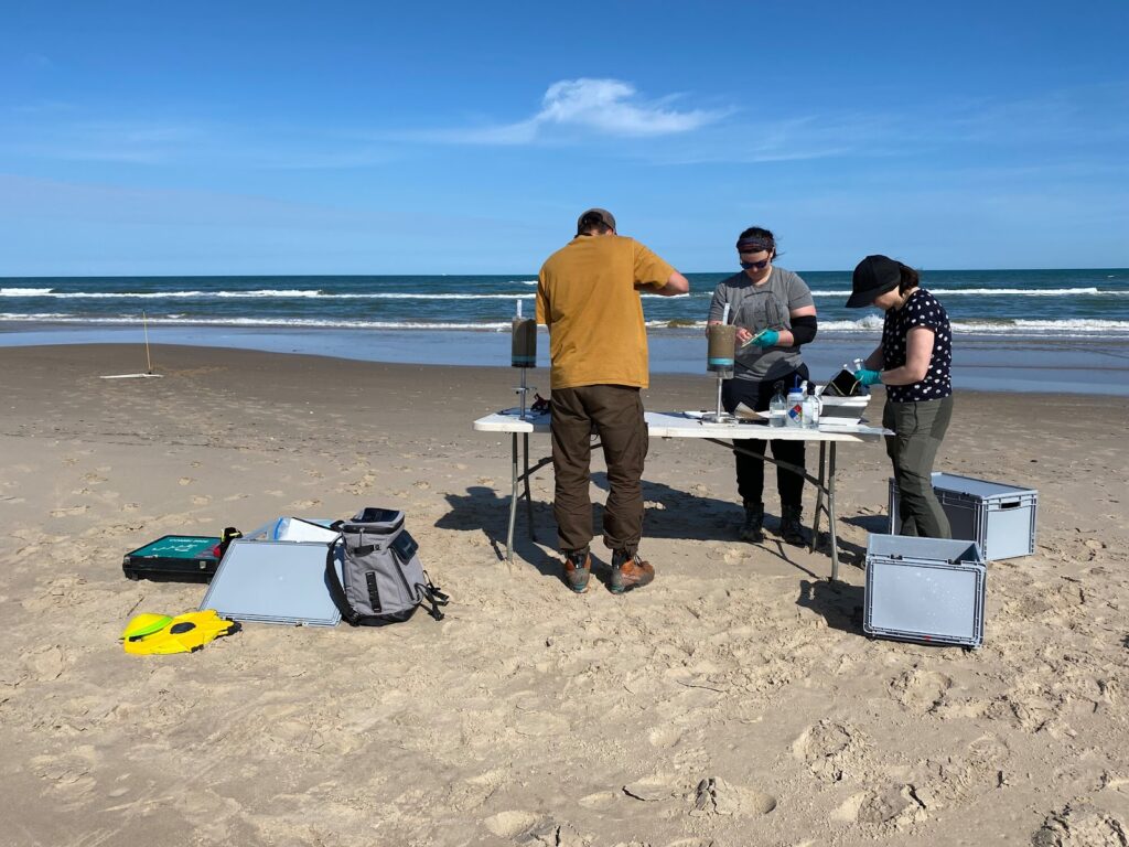 Scientists on the coast sampling coastal sands 