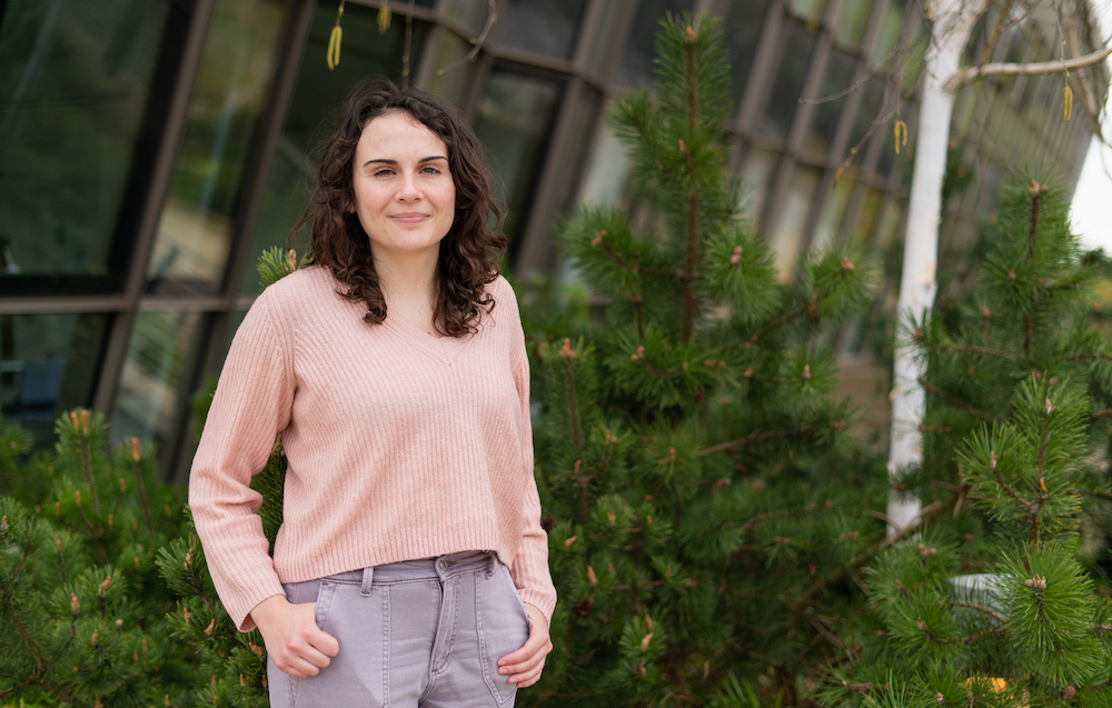 Woman standing in front of hedge