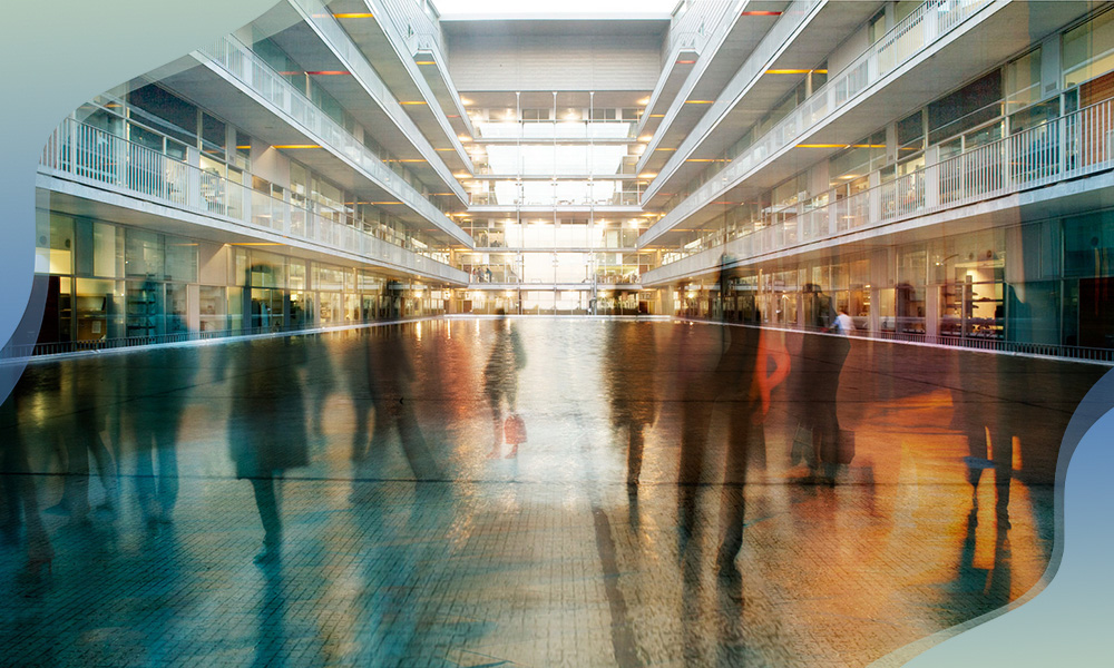 Blurred silhouettes of people walking through the interior of the CRG building