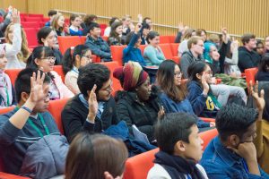 Diverse students sitting in an auditorium.
