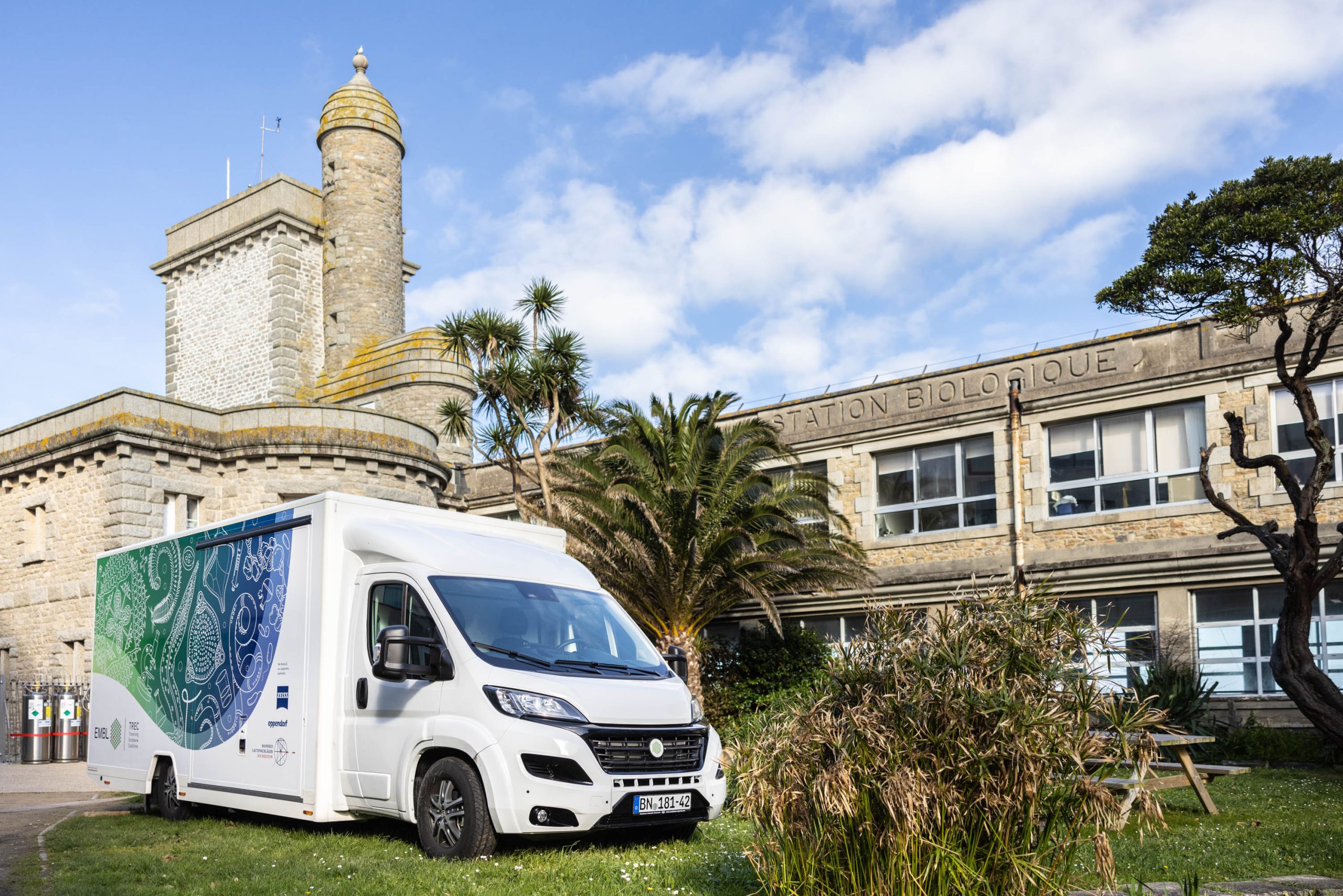 A mobile lab in front of a building.