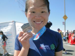 Alumna Siyi Zhang celebrates completing a 12.4K race in San Francisco