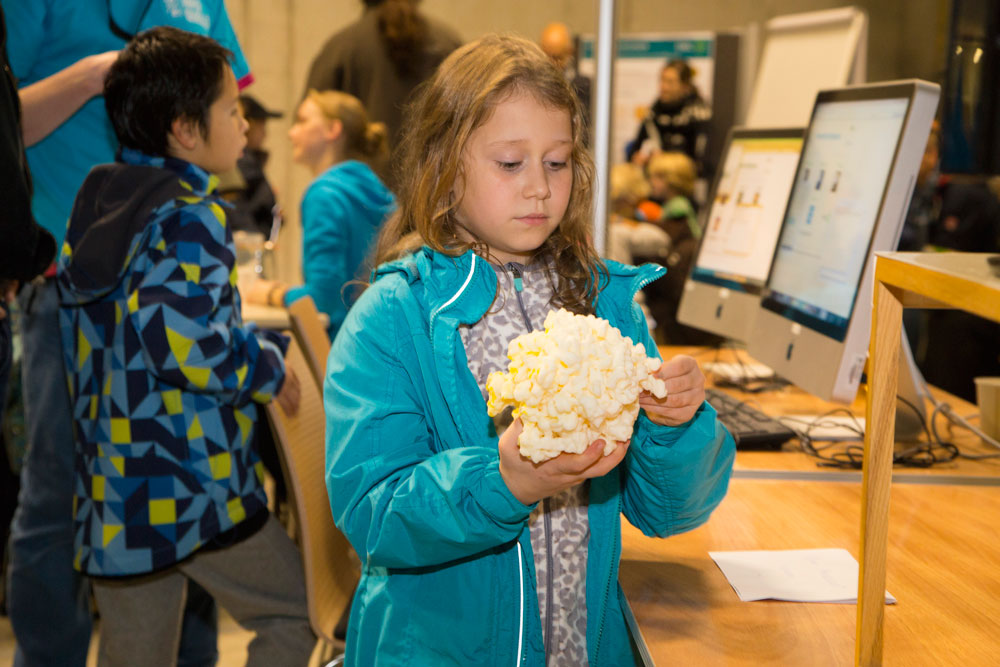 A young visitor takes a closer look at a 3D model of a ribosome. PHOTO: EMBL/Rosemary Wilson