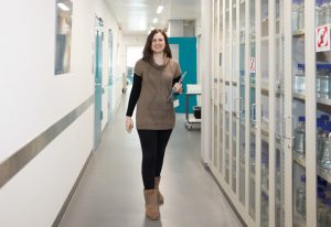 EMBL IT support engineer Vasiliki Karyoti walking down a corridor