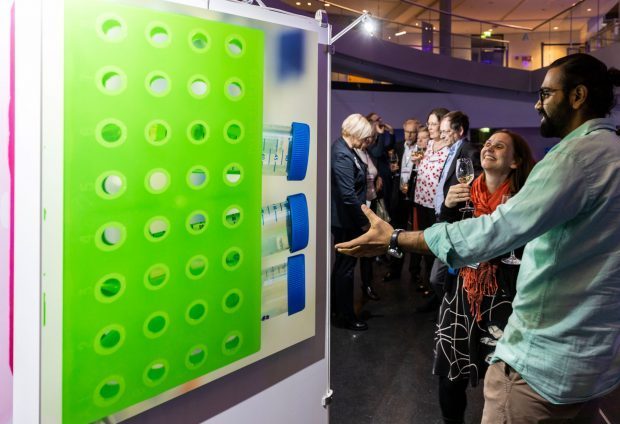 Guest looking at a panel at the REMIX exhibition produced for the European Researchers’ Night 2018