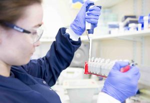 Female scientist pipetting