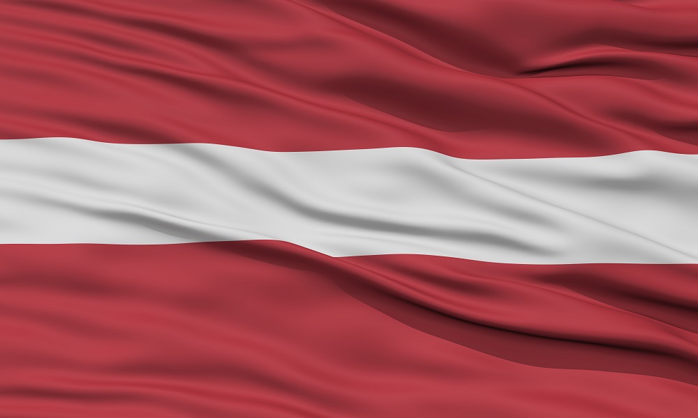 The national flag of Latvia: A carmine field bisected by a narrow white stripe (one-fifth the width of the flag)