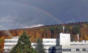 Rainbow above the EMBL building in Heidelberg, surrounded by woods.