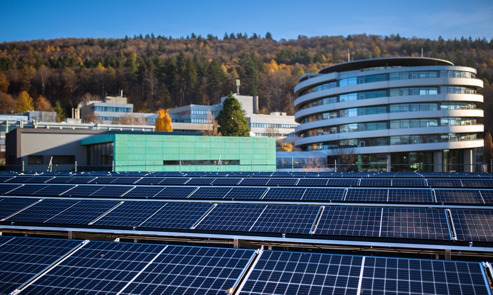 The newly installed solar array at EMBL's site in Heidelberg. In the foreground are rows of solar panels, with the ATC building shown behind.