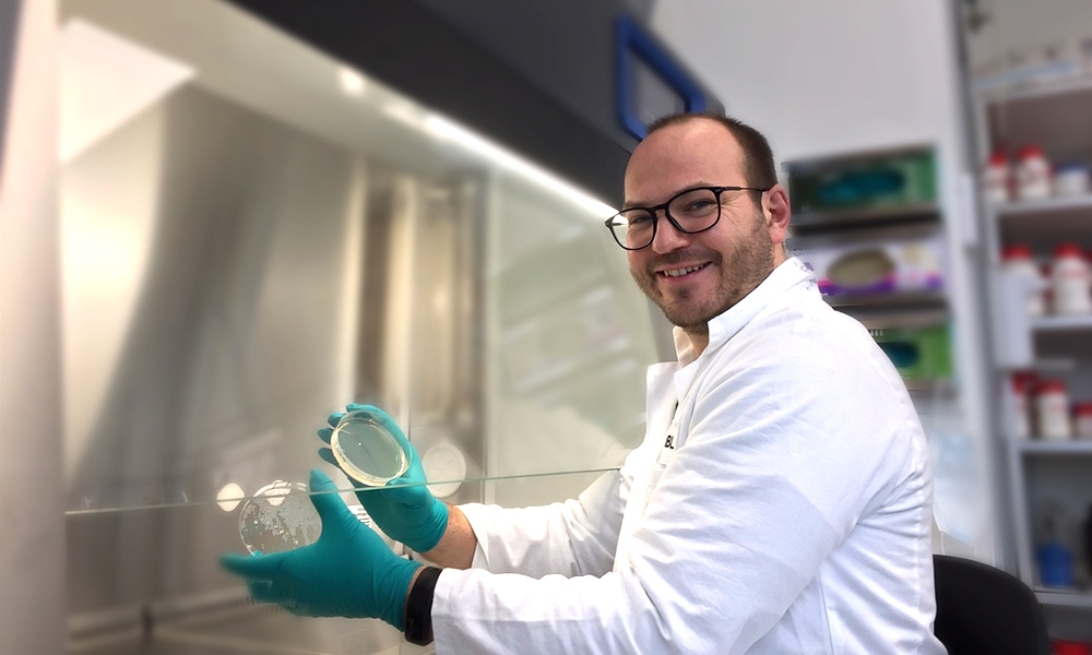 Male scientist in white coat is laboratory setting