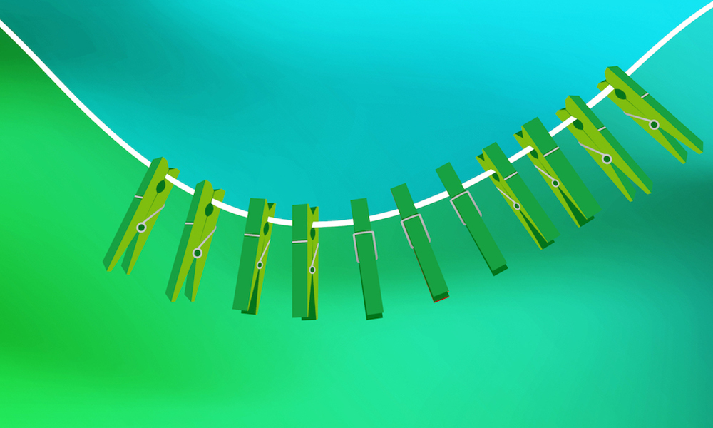 Several clothes pegs are attached to a washing line, which is bent into a curve.