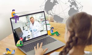 A student in front of a computer watches a scientist working in a laboratory