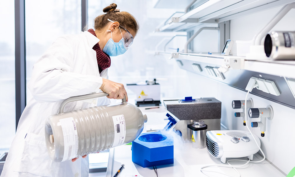 Pia Lavriha pours liquid nitrogen into a sample transfer vessel. 