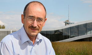 Male scientist in front of Building