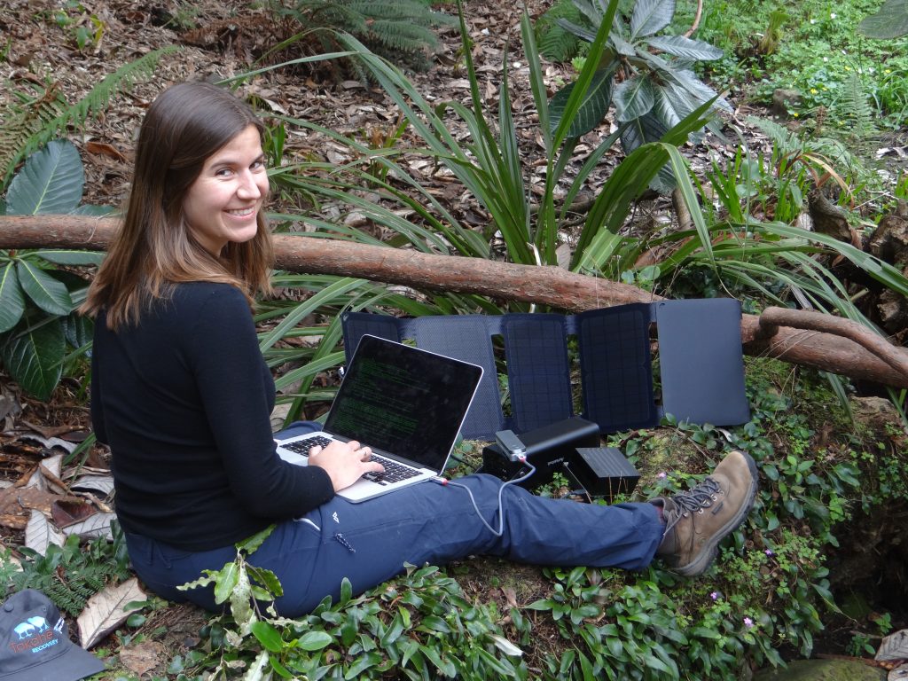 Scientist on laptop, out in the wild