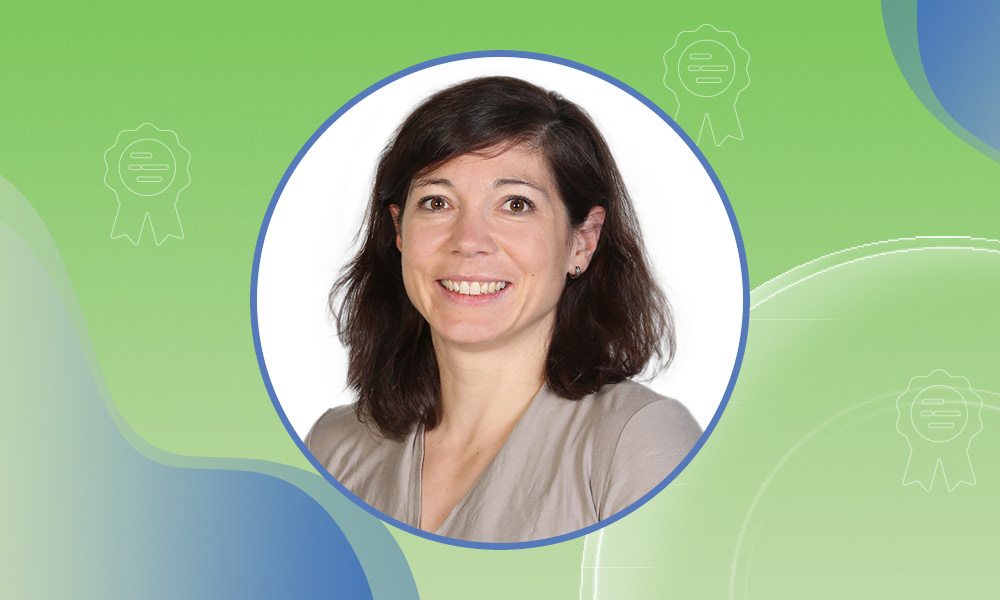 Portrait photo of EMBL Group Leader Judith Zaugg against a green background.