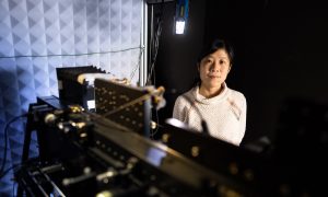 Photo of a female scientists with scientific equipment.