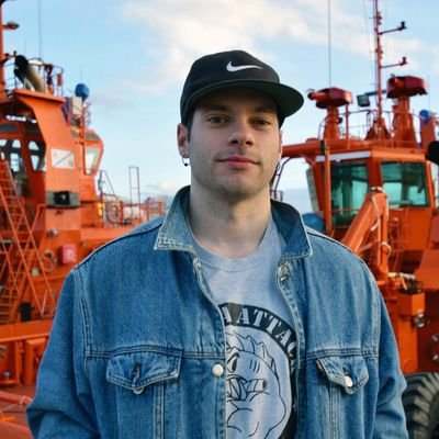 Head shot of male scientist with shipyard in background