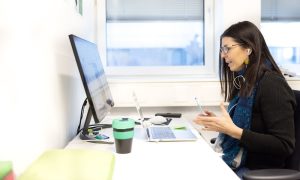 A female career advisor at computer participates in webinar