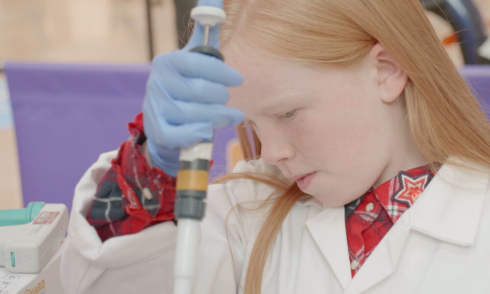 young girl in lab coat