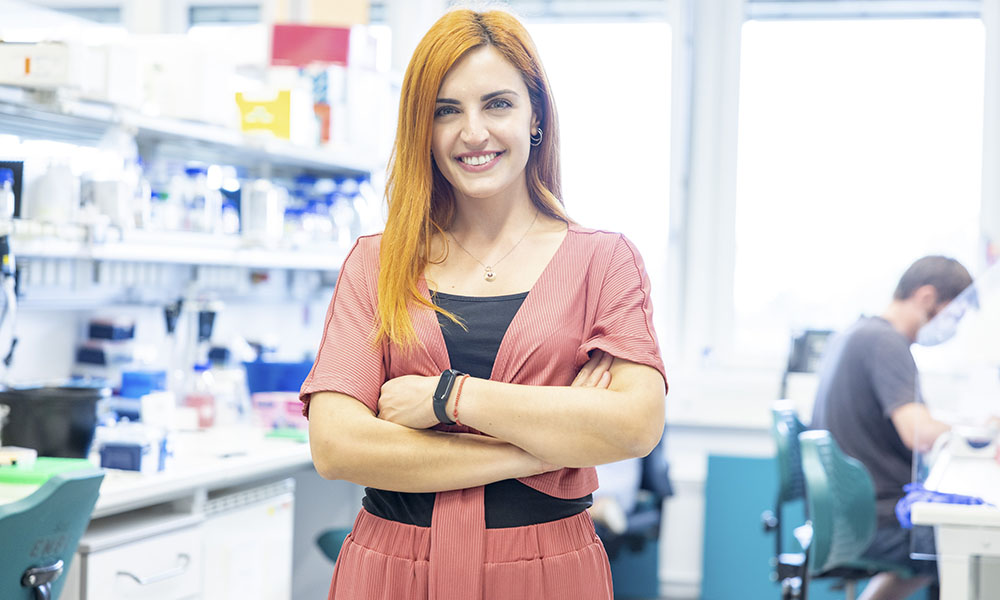 Female scientist stands in laboratory setting