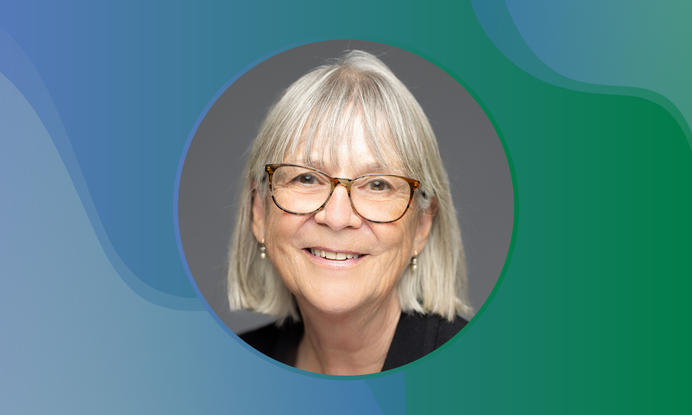 Female scientist photographed against a grey background