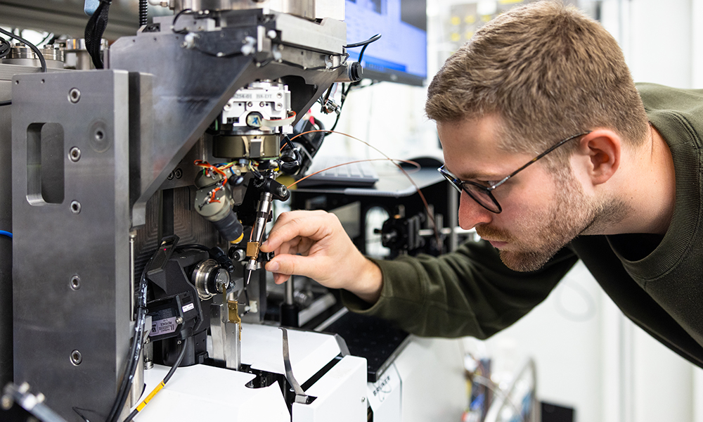 Photo of Kirill Kovalev adjusting the sample injector at EMBL Hamburg’s P14 beamline.