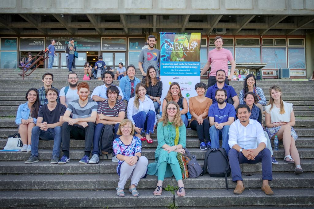 Group photograph showing workshop participants seated on a staircase