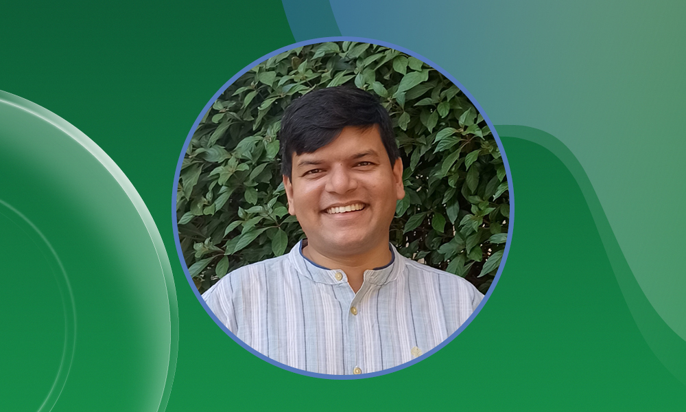Portrait photo of Vikas Trivedi, with a green background