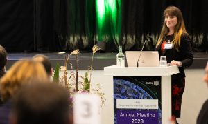 woman speaking at podium at meeting