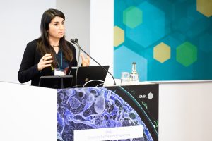 female scientist speaking at podium 