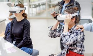 two students wear virtual reality headsets