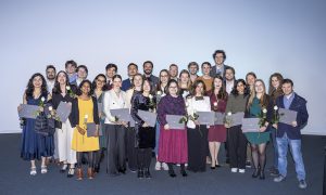 Group photograph of people facing the camera holding certificates.