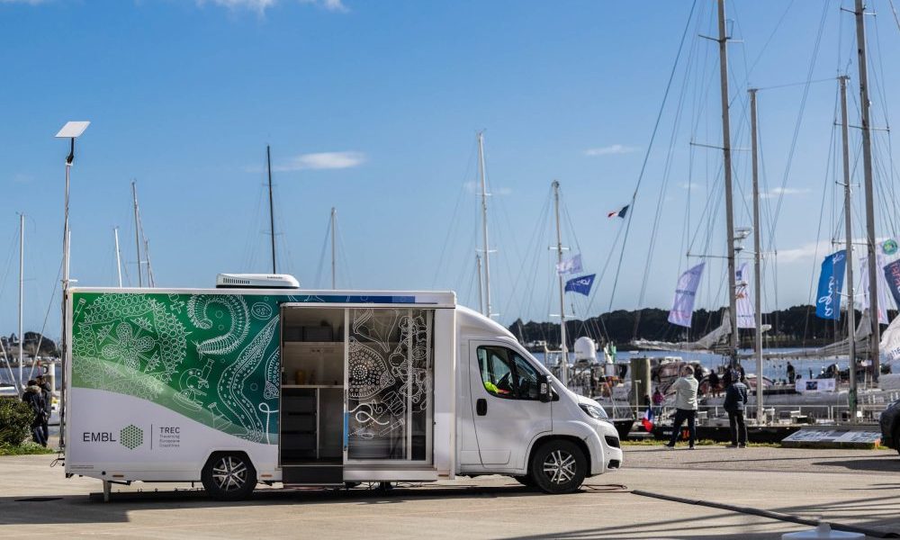 A mobile lab on a road, with the TREC logo on the side.