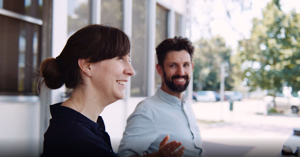 Two scientists, female and male, photographed outdoors.