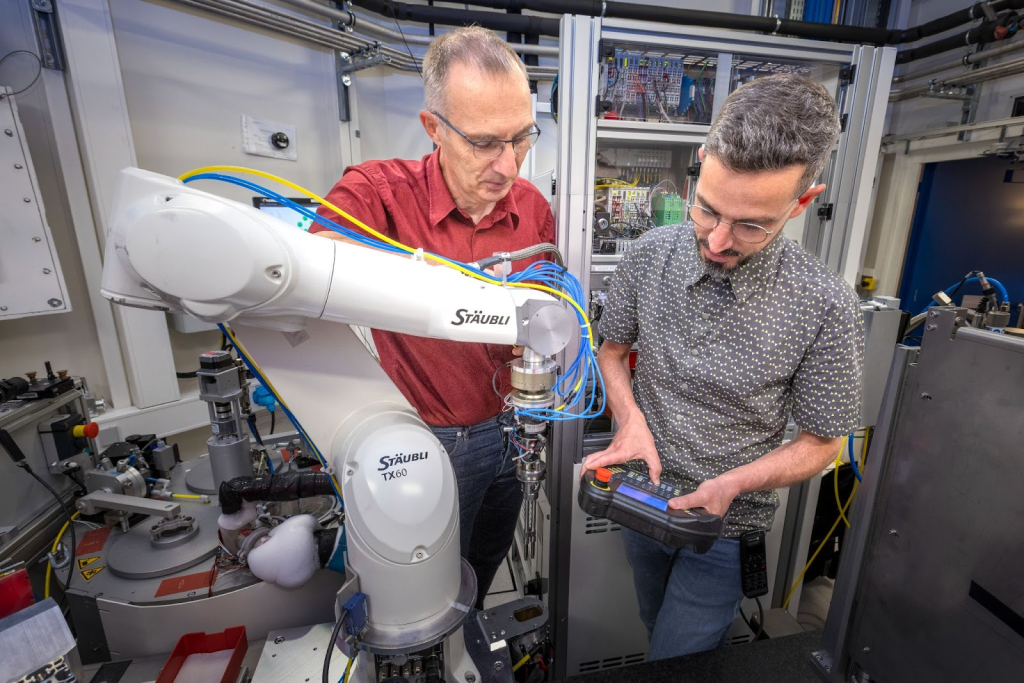 Two male engineers working with lab equipment. 