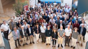 Group of scientists attending symposium staring upward to the photographer.