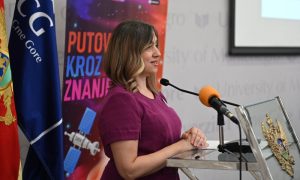 Female politician standing at a podium addressing an audience