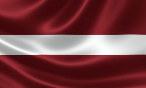 Latvian flag comprised of deep red with a horizontal white stripe across the center