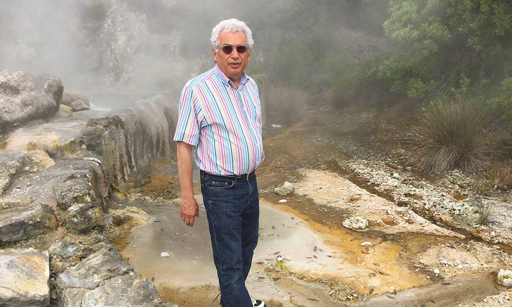 Photo of Garo Antranikian standing next to a steaming lake in Azores.