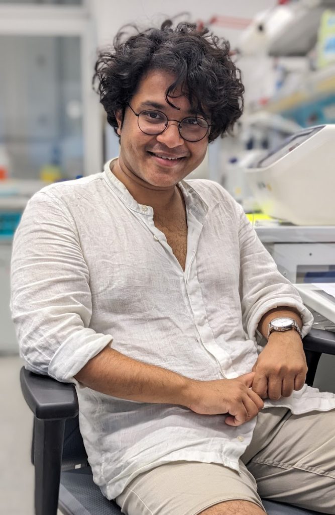 Male scientist sitting on a chair inside a laboratory