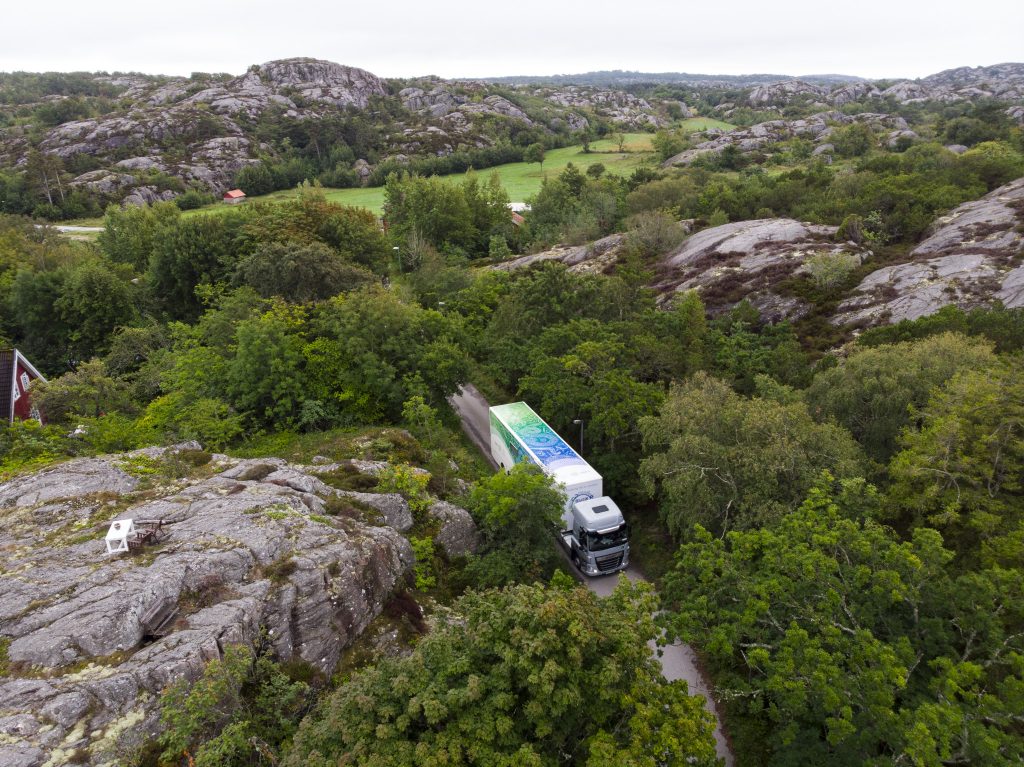 An overhead drone image showing the AML making its way through a narrow hilly road in Sweden. 