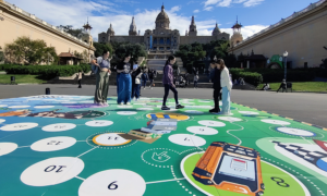 People stand on a life-size game board in front of the magic fountain in Barcelona.