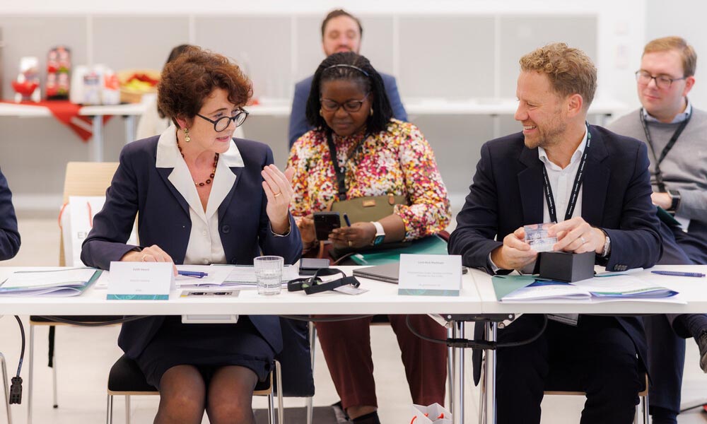 Heard sits at table with other high-level representatives, discussing AI use in life sciences.