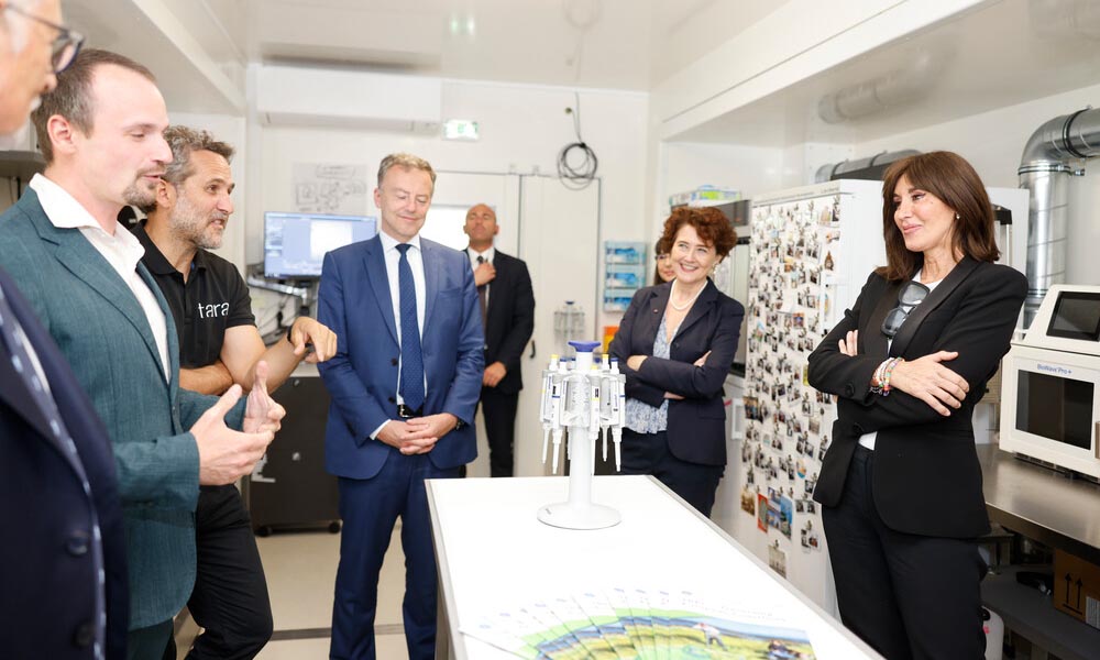 A group of high-level officials listen to briefing inside EMBL's Advanced Mobile Lab.